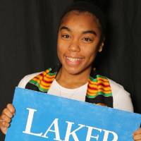a student holding Laker for Lifetime sign